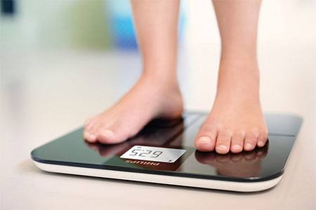 Person stepping on a body fat analyzer