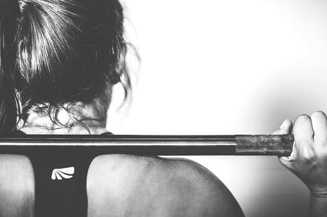 Woman with a barbell on her back